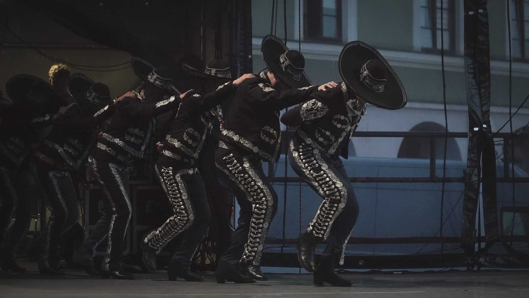 A line of charros in black and silver
